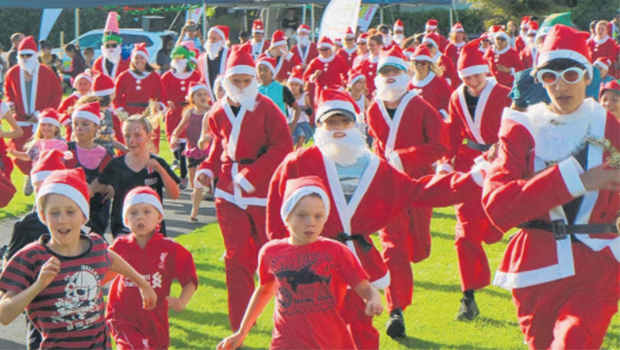 kids running in Santa Suits